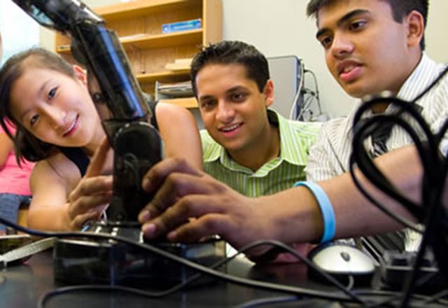 Students gather around project