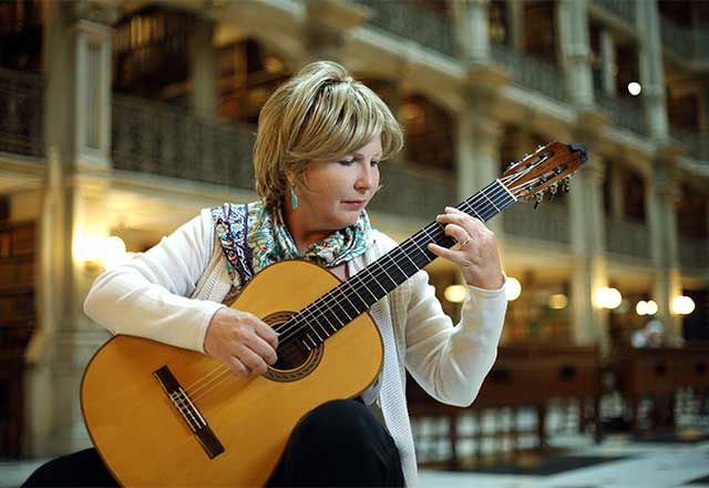 Occupational therapist, Serap Bastepe-Gray, playing a guitar