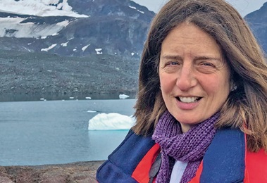 Clara in front of a mountainside lake