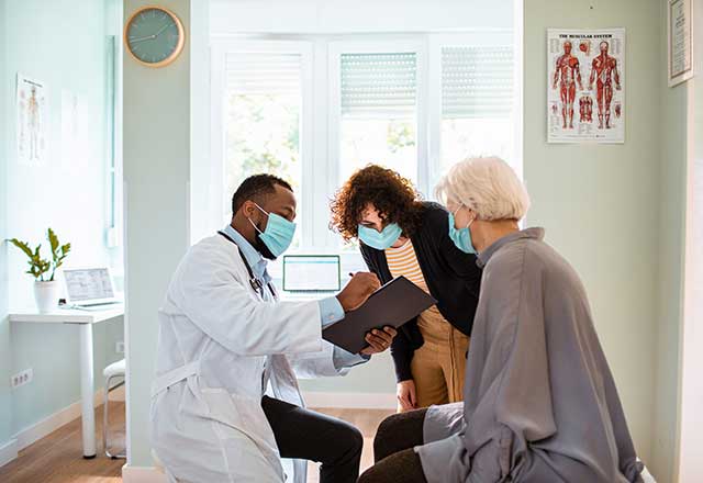 Masked patient in the doctors office