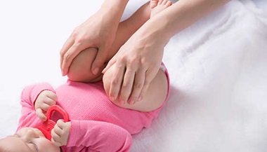 Doctor examining baby's hips.