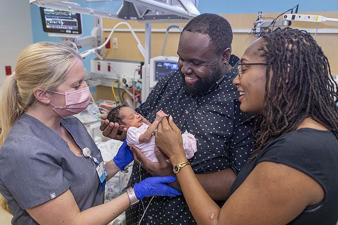 Parents Caprice and Marcus with baby Ari in the neonatal intensive care unit (NICU) at Johns Hopkins All Children's.