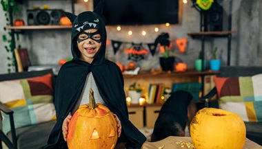 A young child celebrates Halloween dressed in costume