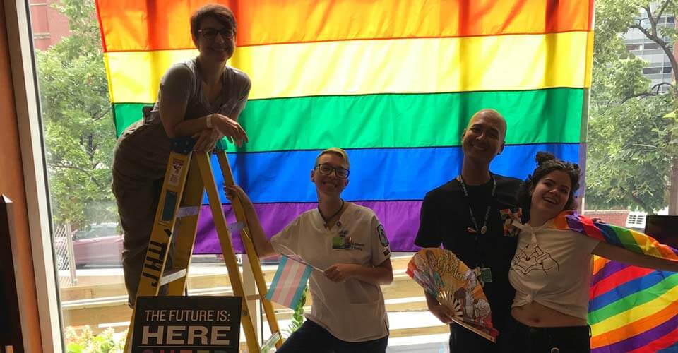 Hopkins students in front of pride flag