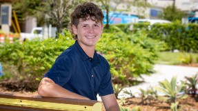 A portrait of Jake sitting outside. Jake was treated for a traumatic brain injury at Johns Hopkins All Children's Hospital.