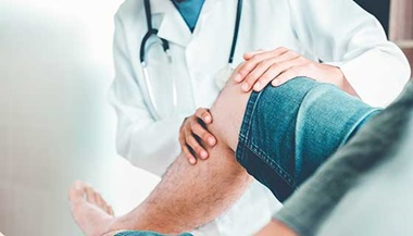 Doctor examining a patient's knee