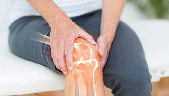 Woman holding knee in pain