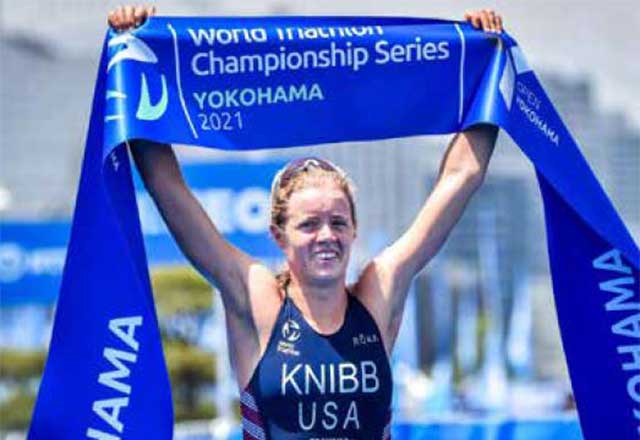 Olympian Taylor Knibb holding up a world marathon championship series.