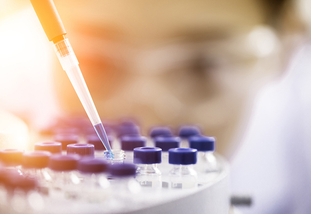 Researcher working with test tubes