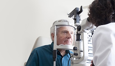 senior man receiving eye exam