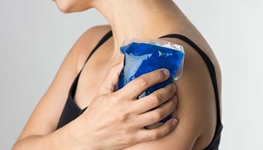 Woman holding an ice pack over her shoulder