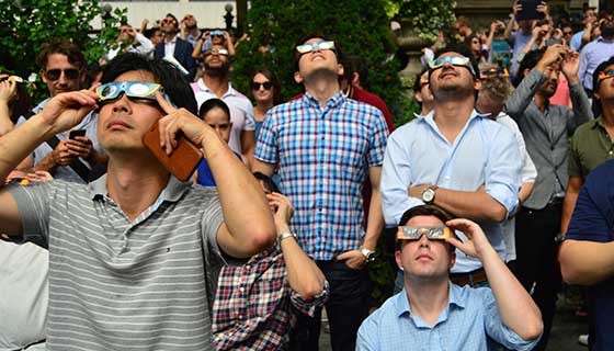 People watching solar eclipse while wearing special glasses