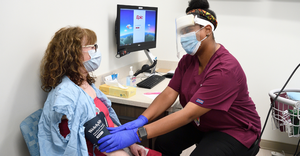 A nurse consults with a patient during an appointment